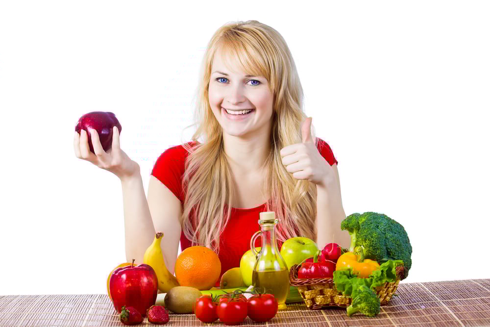 Woman enjoying fruits and vegetables rich in fiber