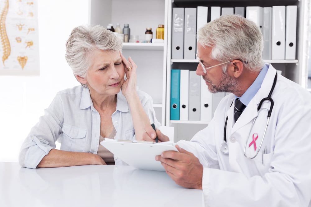 elderly woman speaking with her doctor